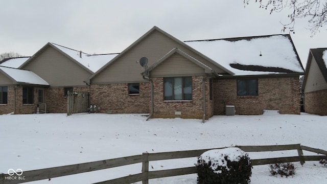 view of snow covered back of property