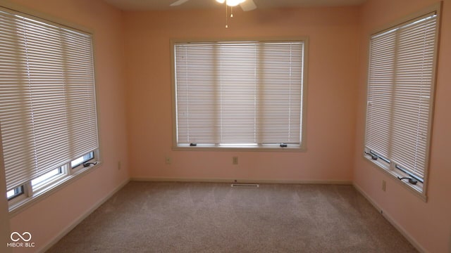 spare room featuring ceiling fan and light colored carpet