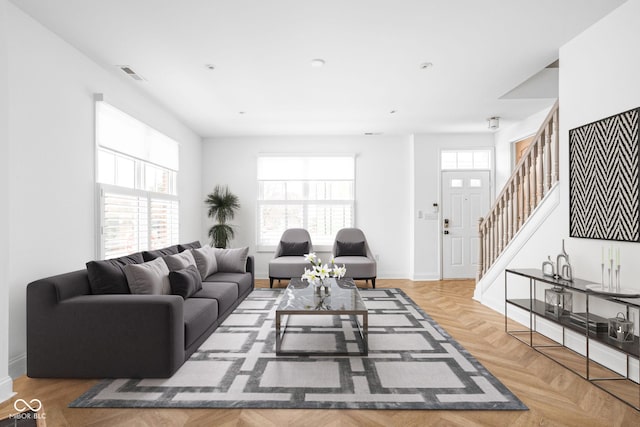 living room with a wealth of natural light and parquet floors