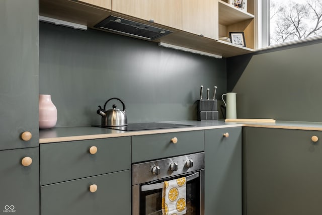 kitchen with black electric cooktop and stainless steel oven