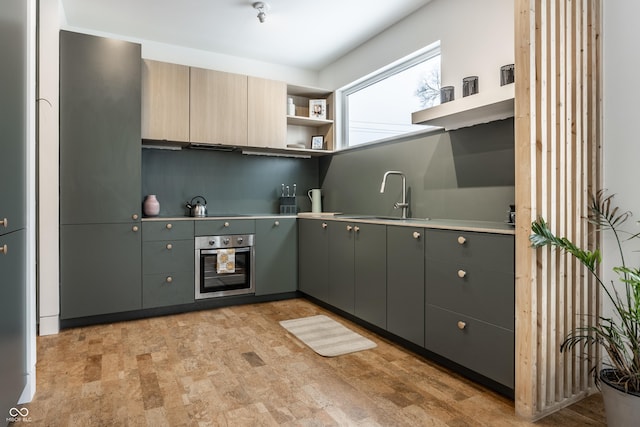 kitchen featuring stainless steel oven, stovetop, and sink