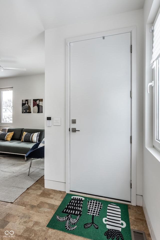 entrance foyer featuring ceiling fan