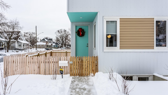 view of snow covered property entrance