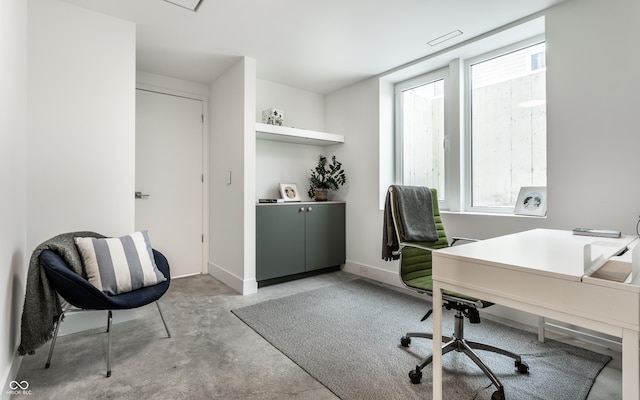 office space with concrete flooring and a healthy amount of sunlight