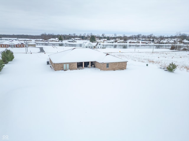 snowy aerial view with a water view