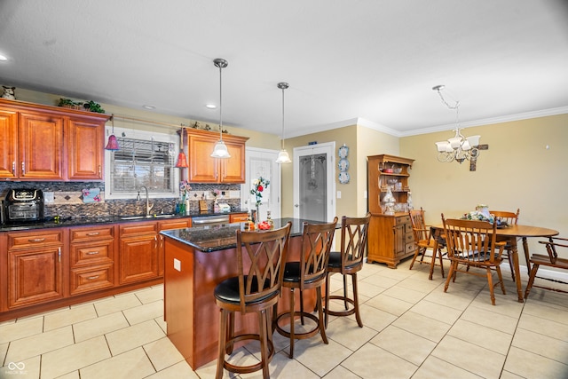 kitchen featuring a center island, decorative light fixtures, a notable chandelier, and sink