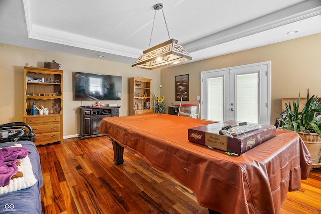 rec room featuring a raised ceiling, french doors, wood-type flooring, and billiards