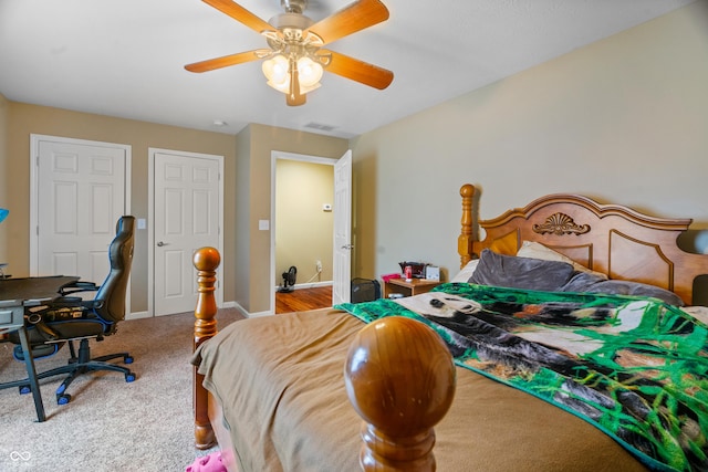 carpeted bedroom featuring visible vents, baseboards, and a ceiling fan