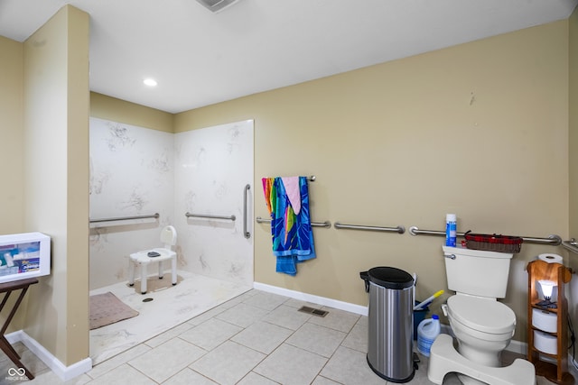 bathroom with tile patterned floors, toilet, baseboards, and visible vents