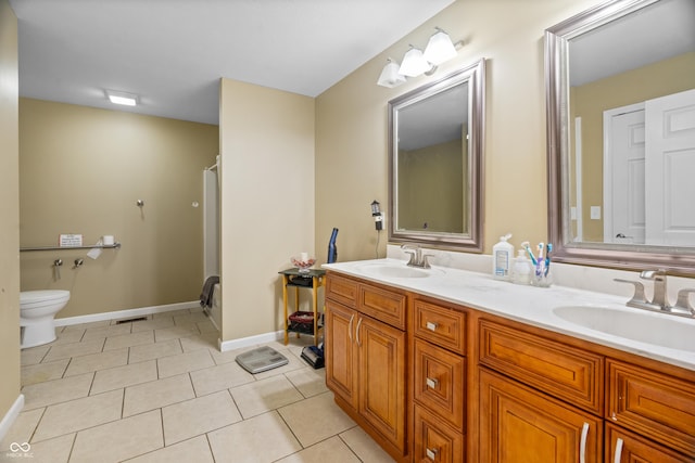 full bath featuring tile patterned flooring, double vanity, toilet, and a sink