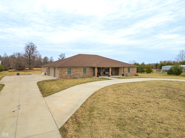 ranch-style house with driveway, brick siding, a porch, and a front lawn