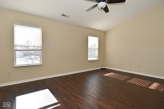 unfurnished room featuring lofted ceiling, ceiling fan, wood-type flooring, and a healthy amount of sunlight