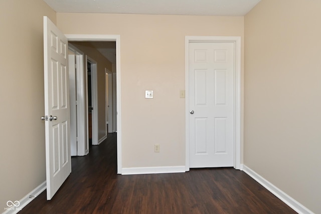 unfurnished bedroom featuring dark wood-type flooring