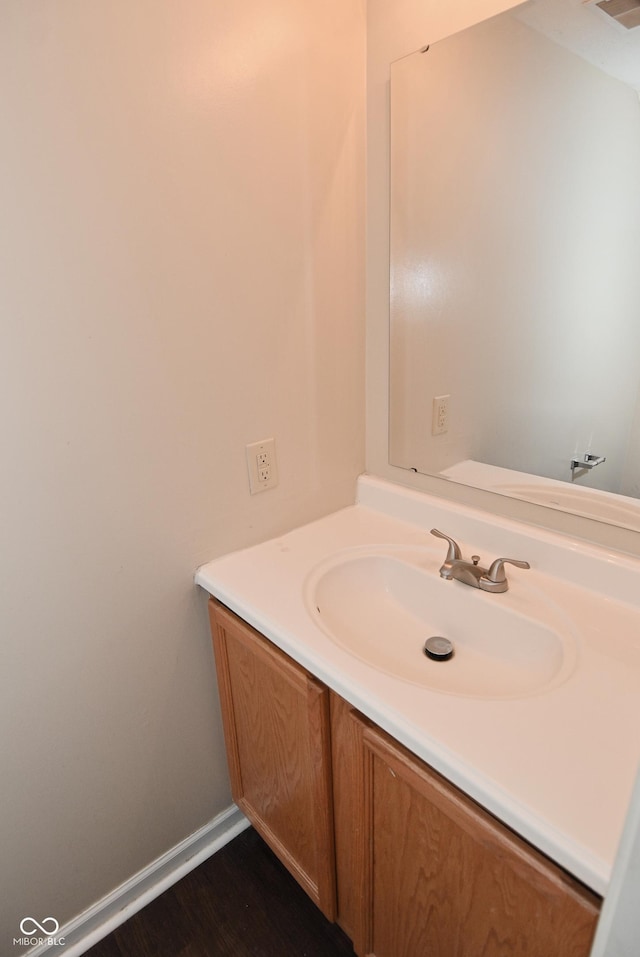 bathroom with vanity and wood-type flooring