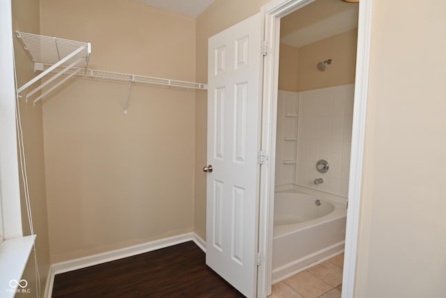 bathroom featuring tile patterned flooring and shower / bath combination