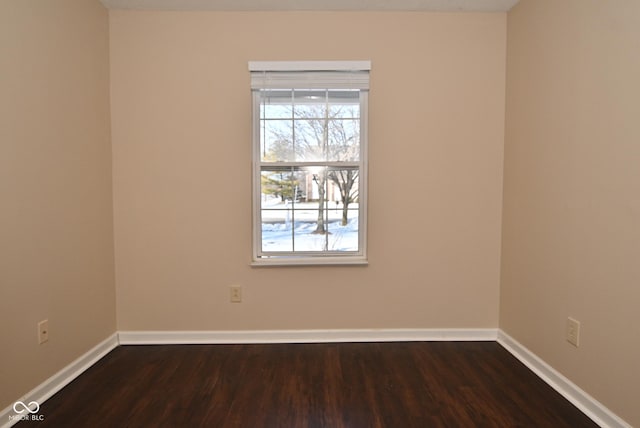 spare room with dark wood-type flooring