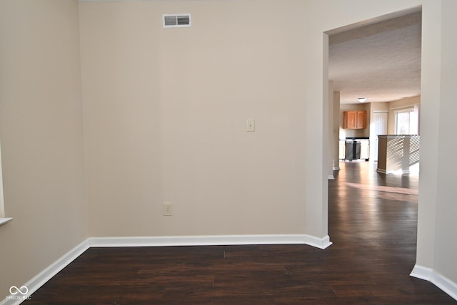 unfurnished room featuring dark hardwood / wood-style floors