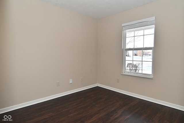 spare room featuring dark hardwood / wood-style floors