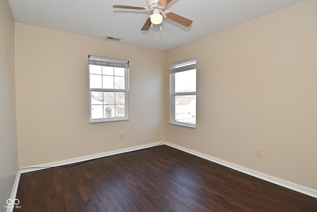 unfurnished room with ceiling fan and dark hardwood / wood-style flooring