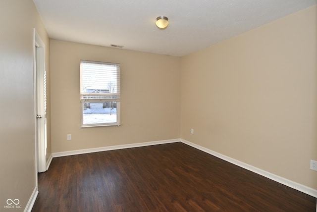 spare room featuring dark hardwood / wood-style flooring