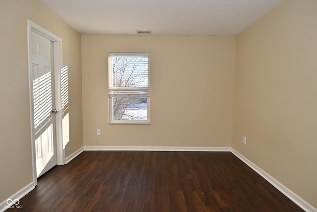 unfurnished room with dark hardwood / wood-style flooring