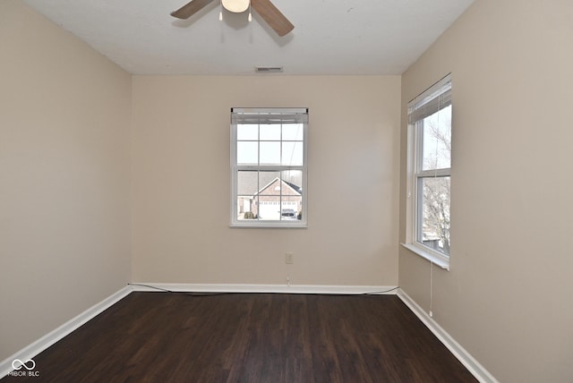 spare room with hardwood / wood-style floors and ceiling fan