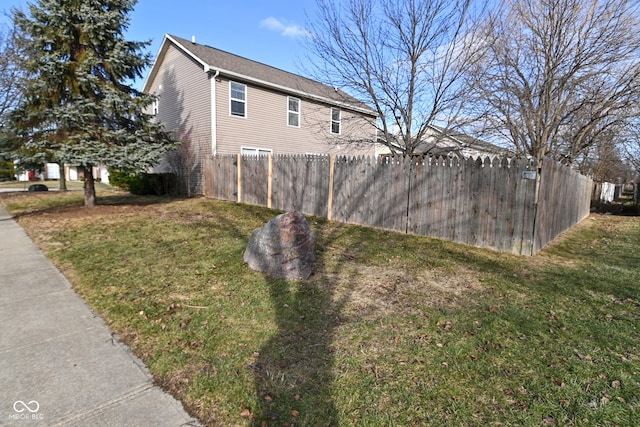 view of side of property with a lawn