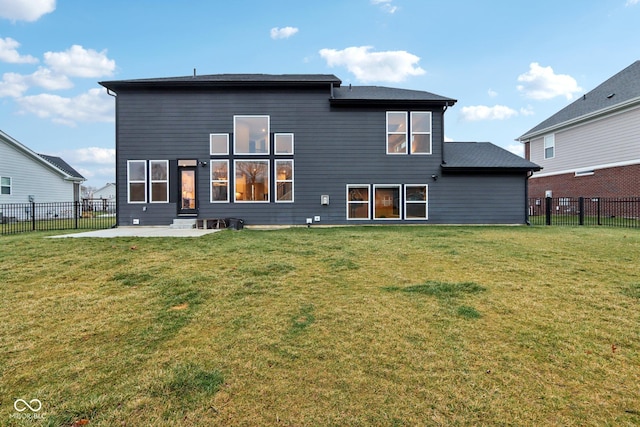 rear view of property with a yard and a patio