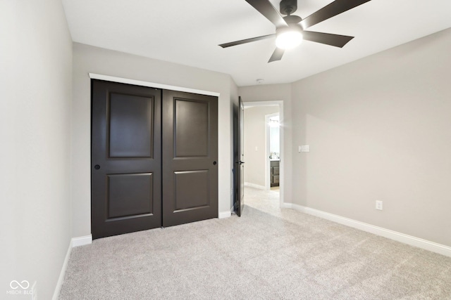 unfurnished bedroom with light carpet, a closet, and ceiling fan