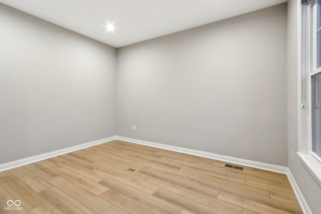 empty room with light hardwood / wood-style flooring