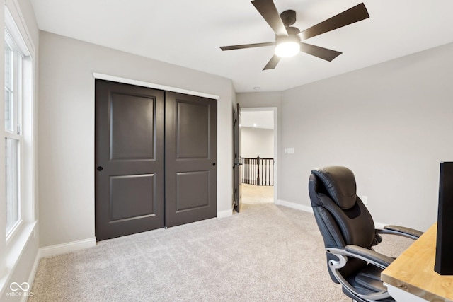 carpeted office featuring ceiling fan