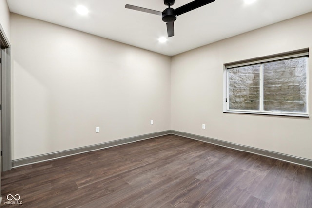 empty room with dark wood-type flooring and ceiling fan