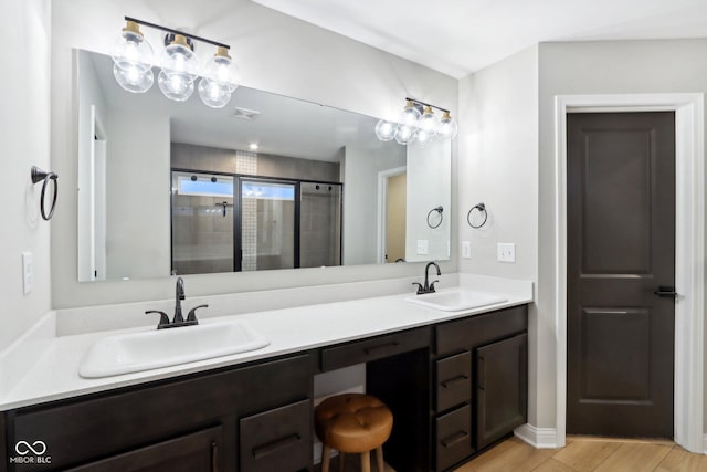 bathroom with vanity and a shower with shower door