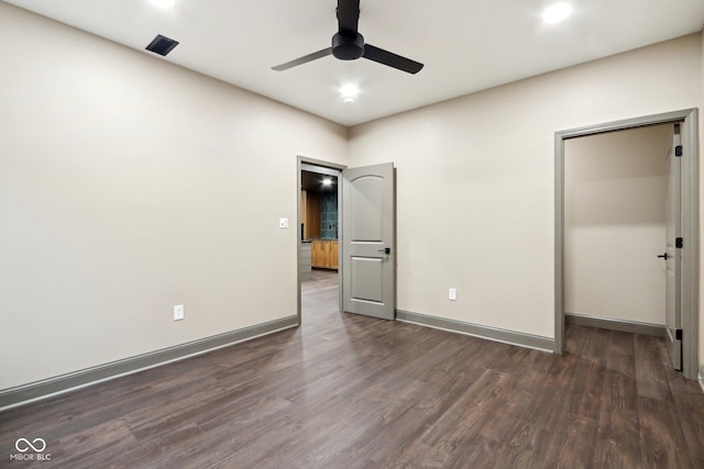 unfurnished bedroom featuring dark wood-type flooring, ceiling fan, and a closet