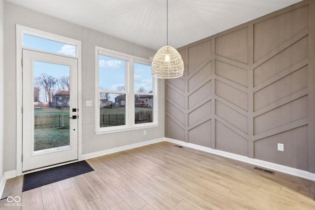 unfurnished dining area with wood-type flooring