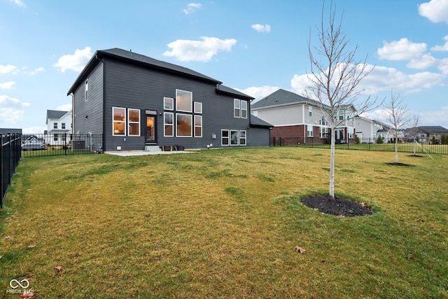 rear view of house with a yard and central air condition unit