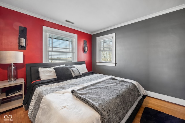 bedroom with dark hardwood / wood-style flooring and ornamental molding