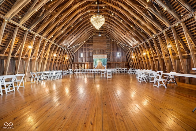 miscellaneous room with vaulted ceiling with beams and hardwood / wood-style flooring