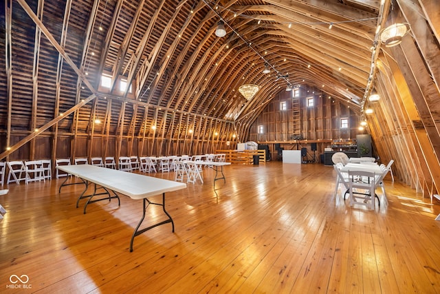 interior space featuring hardwood / wood-style floors and vaulted ceiling