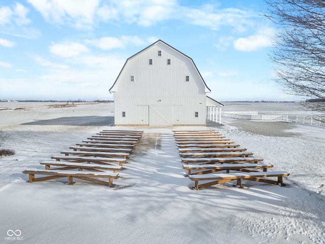 snow covered property featuring an outdoor structure