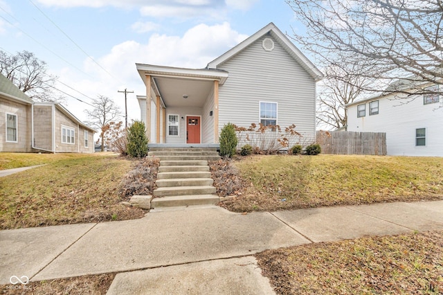 view of front of property with fence and a front lawn