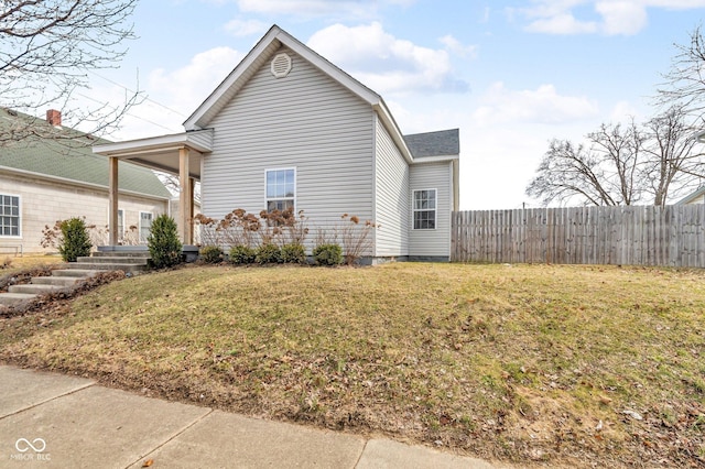 view of side of property with a yard and fence