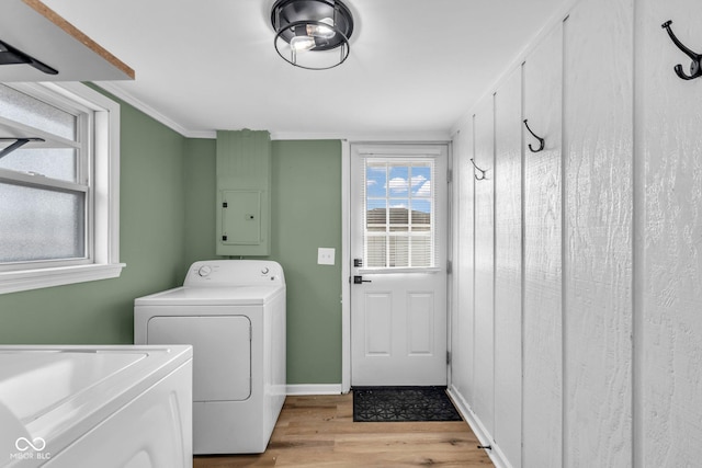 laundry area with light wood-style floors, ornamental molding, laundry area, independent washer and dryer, and baseboards