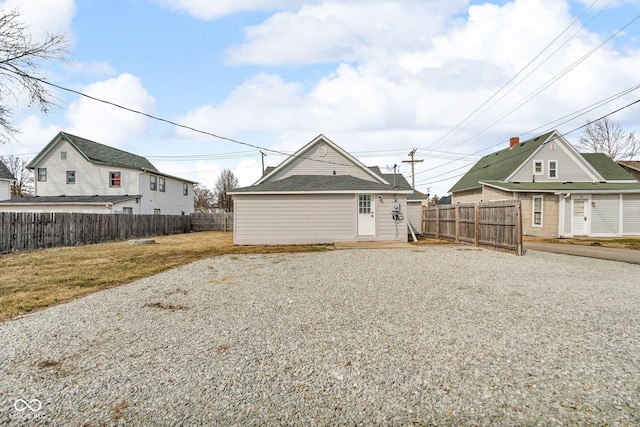 exterior space with fence, an outbuilding, and a front yard