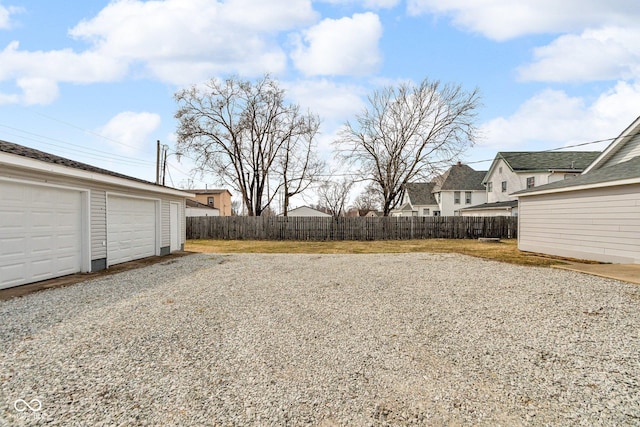 view of yard featuring fence and an outbuilding