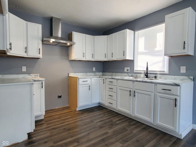 kitchen featuring dark hardwood / wood-style flooring, white cabinetry, sink, and wall chimney exhaust hood