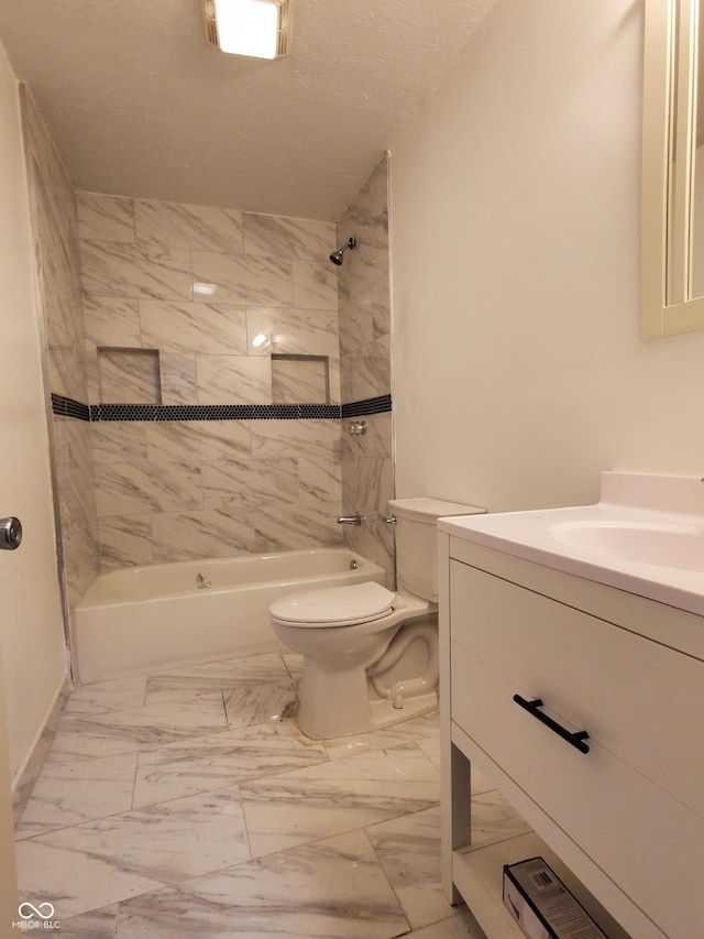 full bathroom with toilet, vanity, and tiled shower / bath combo