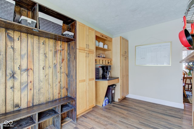 mudroom featuring a textured ceiling and hardwood / wood-style flooring