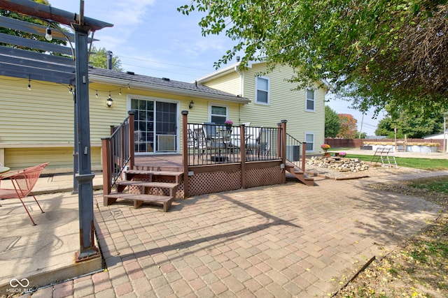 back of property featuring a patio area and a wooden deck