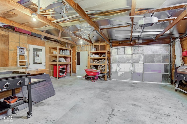 garage with electric panel and a garage door opener